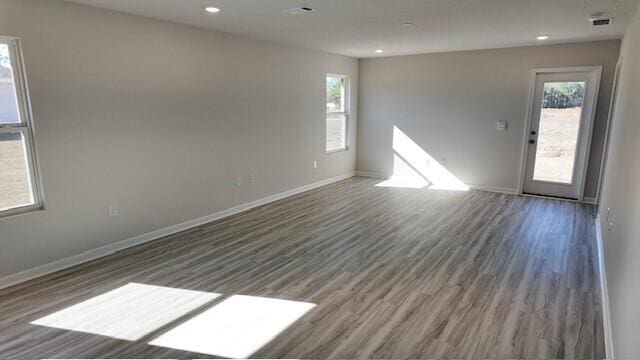 unfurnished room with dark hardwood / wood-style floors