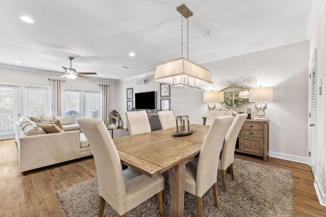 dining area with wood-type flooring, ceiling fan, and crown molding