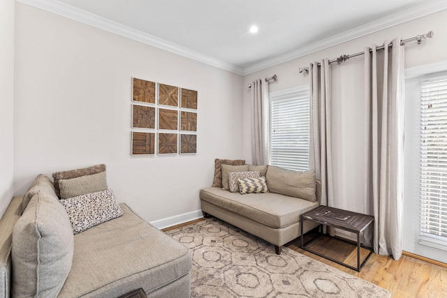 living area with wood-type flooring and crown molding