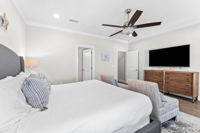 bedroom featuring ceiling fan, wood-type flooring, and ornamental molding