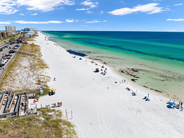 bird's eye view with a water view and a beach view