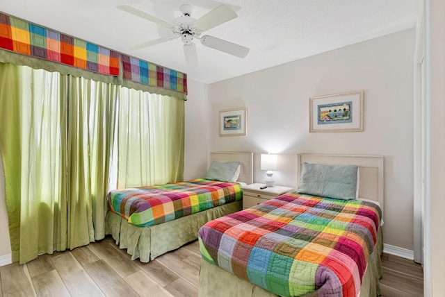 bedroom with ceiling fan and light wood-type flooring