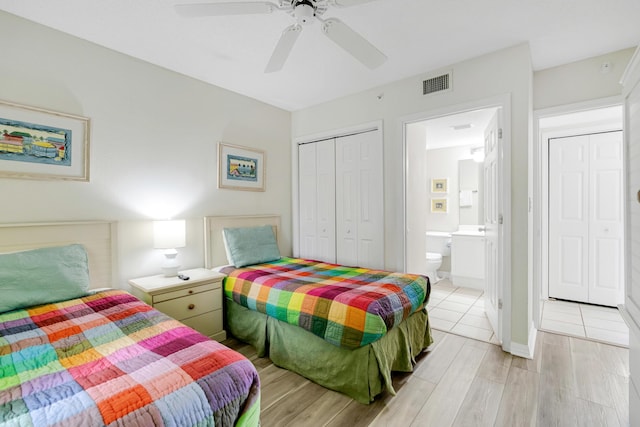 bedroom with a closet, light hardwood / wood-style floors, ensuite bath, and ceiling fan