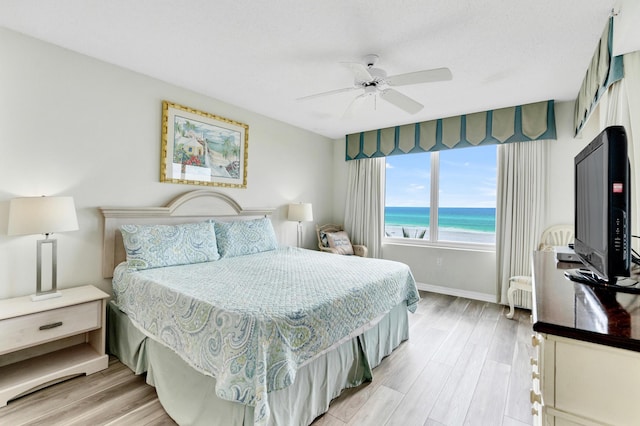 bedroom featuring radiator, ceiling fan, and hardwood / wood-style flooring