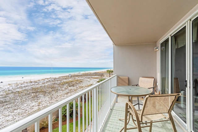 balcony with a view of the beach and a water view