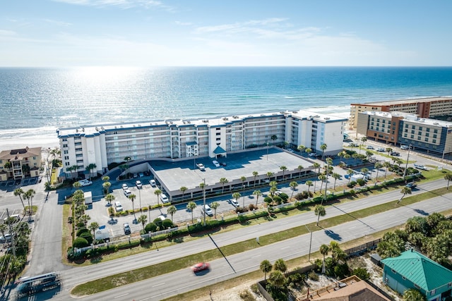 drone / aerial view featuring a beach view and a water view