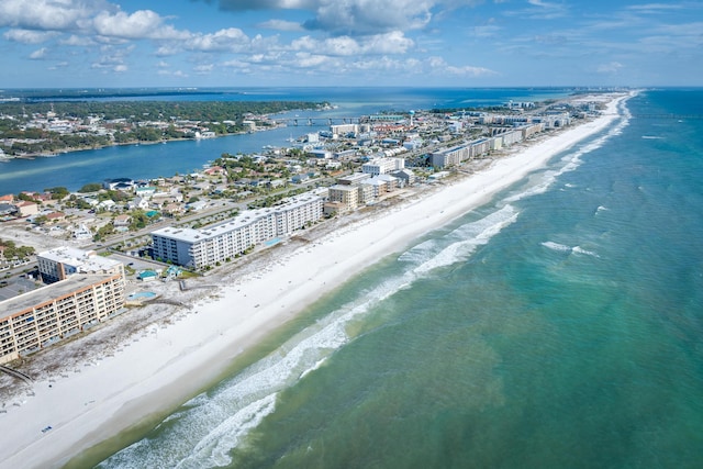 birds eye view of property with a water view and a beach view