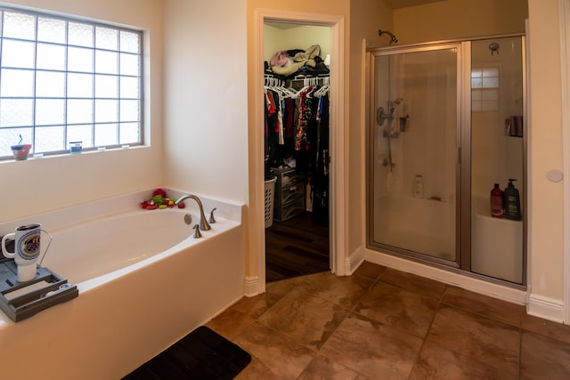 bathroom with separate shower and tub