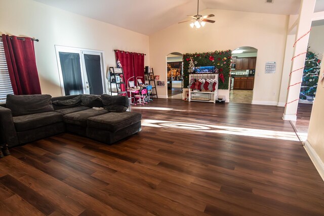 living room featuring ceiling fan, dark wood-type flooring, and high vaulted ceiling