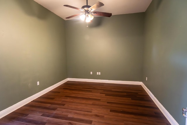 unfurnished room featuring dark wood-style flooring, ceiling fan, and baseboards