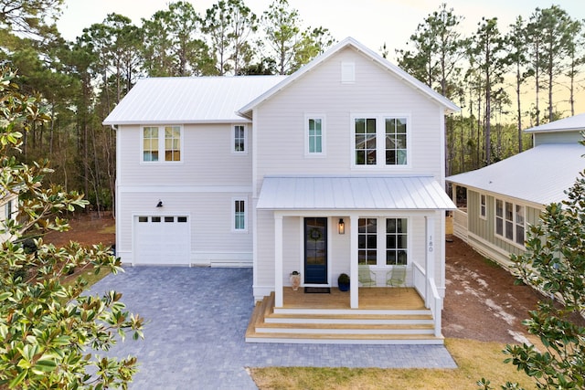 view of front of house with a porch and a garage