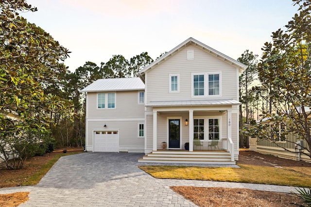 view of front facade featuring a porch and a garage