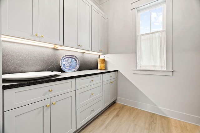 clothes washing area featuring light hardwood / wood-style flooring