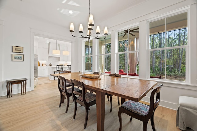 dining area with a chandelier and light hardwood / wood-style floors