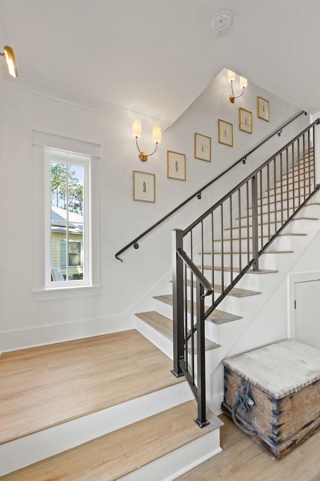 stairway with hardwood / wood-style flooring