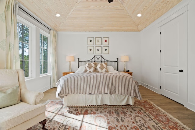 bedroom featuring hardwood / wood-style floors, lofted ceiling, ceiling fan, and wood ceiling