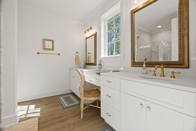 bathroom featuring a shower, wood-type flooring, vanity, and crown molding