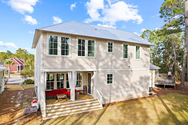 rear view of property with a lawn