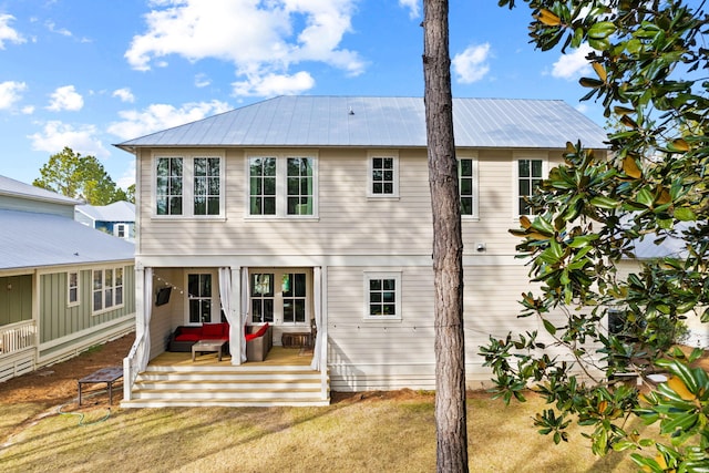 rear view of property with a lawn