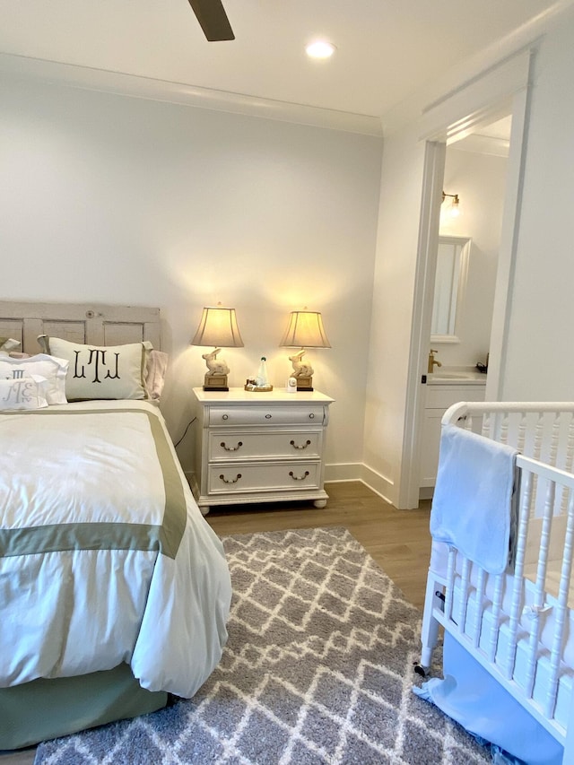 bedroom featuring ceiling fan, dark hardwood / wood-style flooring, and ornamental molding