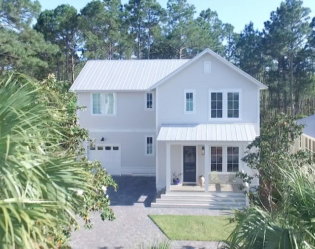 view of front facade featuring covered porch and a garage