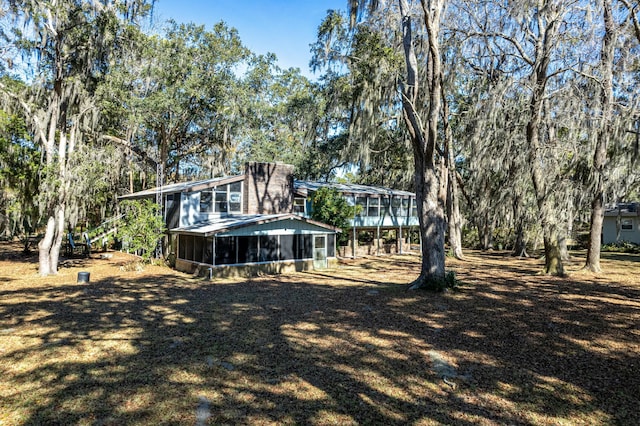 view of yard with a sunroom