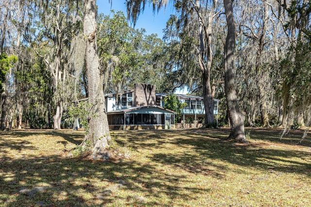 view of yard with a sunroom