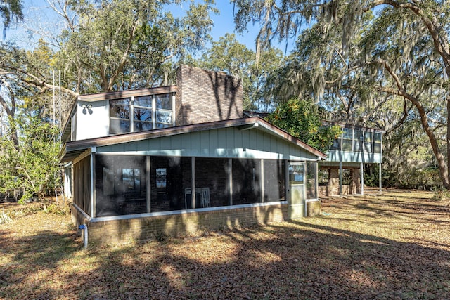 back of house with a sunroom