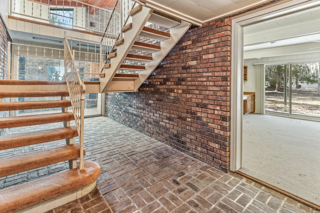 stairs featuring brick wall