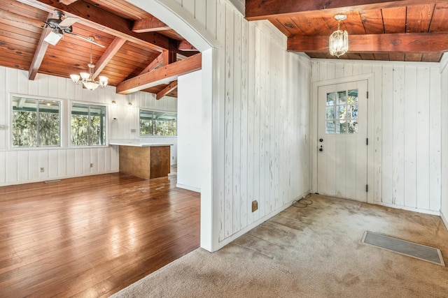 entrance foyer with a healthy amount of sunlight, vaulted ceiling with beams, wooden ceiling, and a chandelier