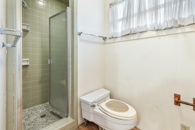 bathroom with walk in shower and toilet