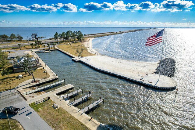 drone / aerial view featuring a water view and a beach view