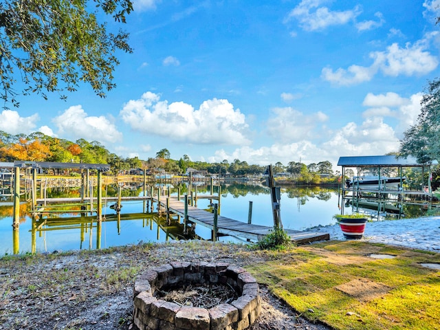 dock area with a water view and a fire pit