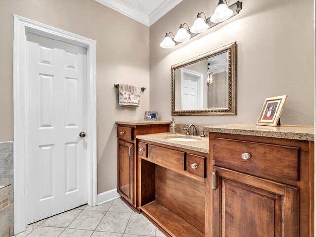 bathroom featuring tile patterned flooring, vanity, and crown molding