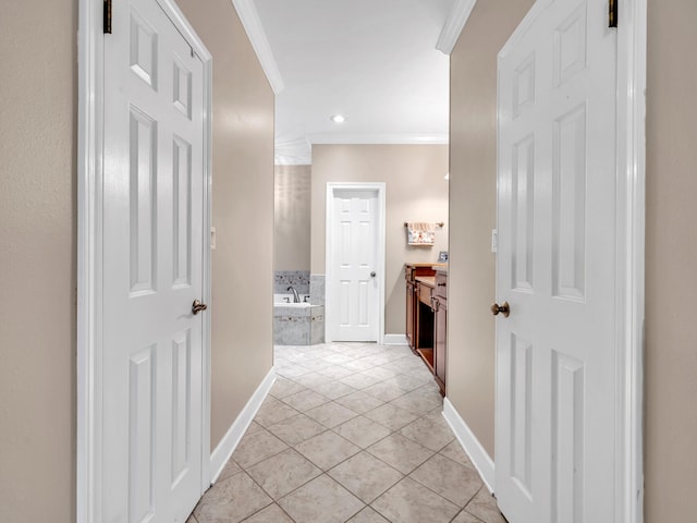 hall with crown molding and light tile patterned floors