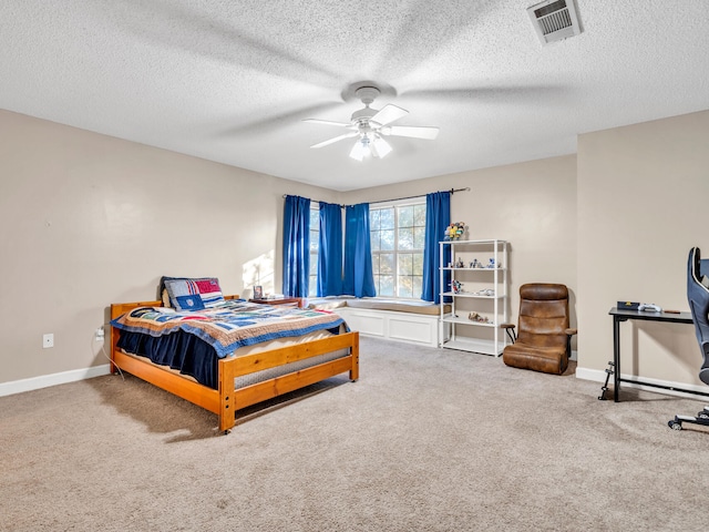 bedroom featuring ceiling fan, carpet, and a textured ceiling