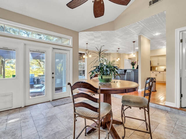 dining room with french doors, light hardwood / wood-style flooring, ceiling fan, and a healthy amount of sunlight