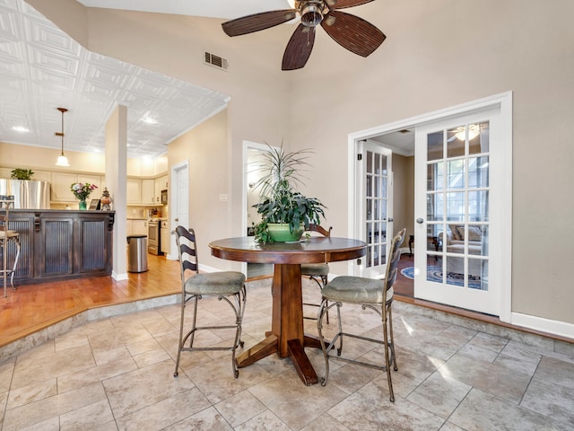 dining room featuring ceiling fan, french doors, and light wood-type flooring