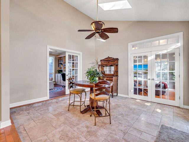 dining area with french doors, a skylight, and a healthy amount of sunlight