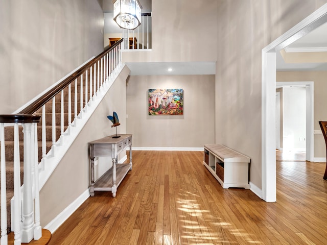 interior space featuring hardwood / wood-style floors, a notable chandelier, and crown molding