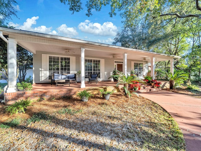 exterior space featuring ceiling fan and a porch