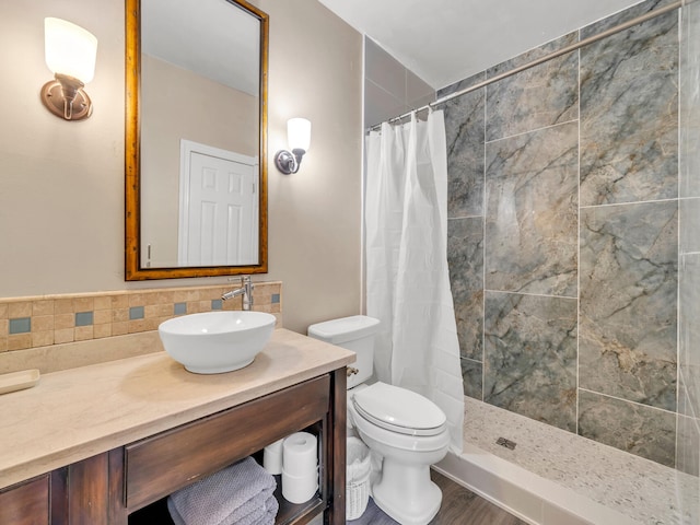 bathroom featuring hardwood / wood-style flooring, vanity, toilet, and walk in shower