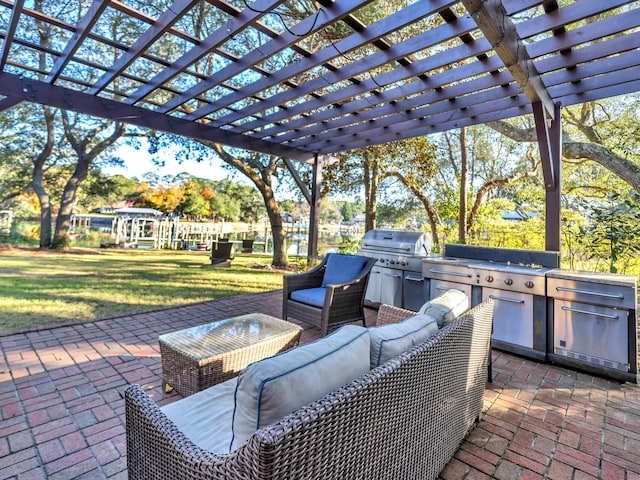 view of patio with an outdoor kitchen, a pergola, and a grill