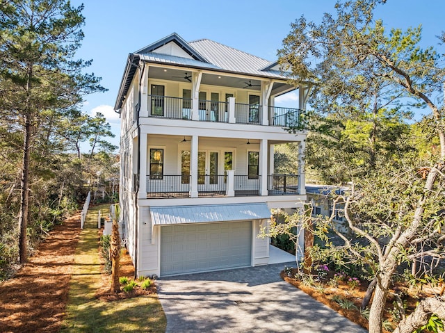 view of front of home featuring french doors, a balcony, and a garage