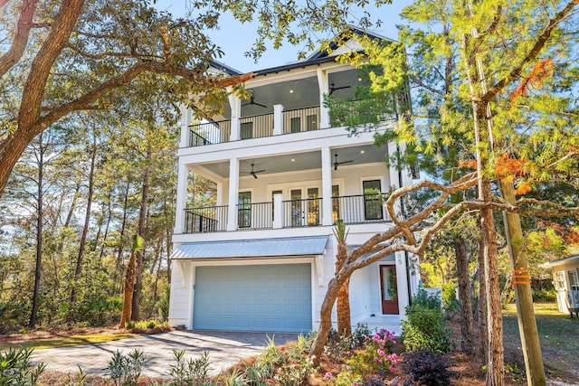 view of front of property with ceiling fan, a balcony, and a garage