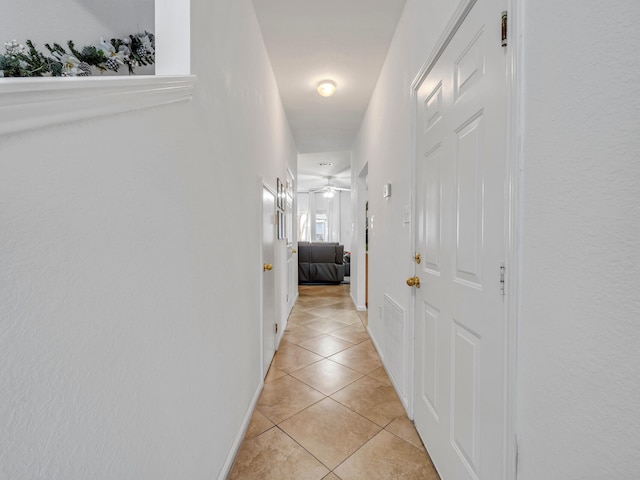 hall with light tile patterned floors