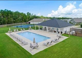 view of swimming pool with a patio area and a yard