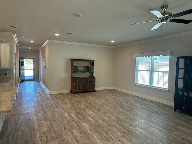 unfurnished living room with crown molding, ceiling fan, and wood-type flooring