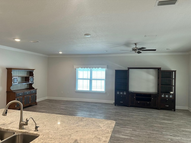 living room with dark hardwood / wood-style flooring, ceiling fan, sink, and ornamental molding