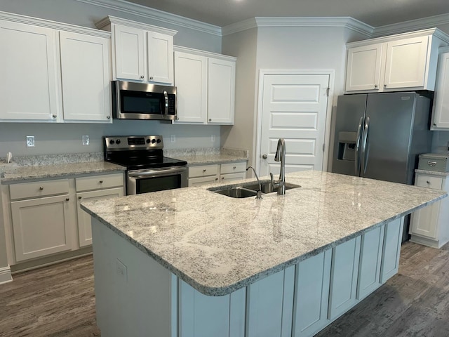 kitchen with white cabinetry, sink, appliances with stainless steel finishes, and an island with sink